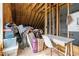 This is a storage space with wooden beams and a desk, offering potential for organization and utility at 2408 Eddie Howard Rd, Willow Springs, NC 27592