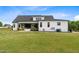 New farmhouse featuring a well-maintained backyard with patio at 2408 Eddie Howard Rd, Willow Springs, NC 27592