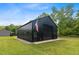 Exterior view of a black metal barn with an American flag, perfect for a workshop or storage at 2408 Eddie Howard Rd, Willow Springs, NC 27592