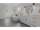 Bright bathroom featuring dual sinks, soaking tub, and modern fixtures at 2408 Eddie Howard Rd, Willow Springs, NC 27592