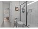 Bright bathroom featuring a tiled walk-in shower and stylish fixtures, exuding modern elegance at 2408 Eddie Howard Rd, Willow Springs, NC 27592