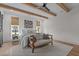 Sun-drenched bedroom featuring a cozy seating area, exposed beams and hardwood flooring at 2408 Eddie Howard Rd, Willow Springs, NC 27592