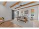 Sun-drenched bedroom featuring a cozy seating area, barn door, and hardwood flooring at 2408 Eddie Howard Rd, Willow Springs, NC 27592