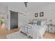 Calm bedroom with decorative wall paneling, a sliding barn door, and ensuite bathroom at 2408 Eddie Howard Rd, Willow Springs, NC 27592