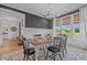 Stylish dining room with modern light fixture, black accent wall and a large patterned rug at 2408 Eddie Howard Rd, Willow Springs, NC 27592