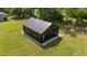 New black metal barn with a black garage door situated on a well maintained lawn at 2408 Eddie Howard Rd, Willow Springs, NC 27592