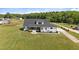 Aerial view of home with manicured lawn, patio, and firepit area at 2408 Eddie Howard Rd, Willow Springs, NC 27592