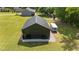New black metal barn with a black garage door with plenty of room for parking at 2408 Eddie Howard Rd, Willow Springs, NC 27592