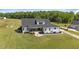 Back aerial view showcasing the home, patio, yard, and landscaping details at 2408 Eddie Howard Rd, Willow Springs, NC 27592