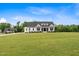 Charming two-story farmhouse with black trim and a manicured front lawn at 2408 Eddie Howard Rd, Willow Springs, NC 27592