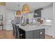 Spacious kitchen featuring a large center island, pendant lighting, white cabinets and stainless steel appliances at 2408 Eddie Howard Rd, Willow Springs, NC 27592