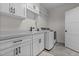 Bright laundry room with modern appliances, ample storage, and utility sink at 2408 Eddie Howard Rd, Willow Springs, NC 27592