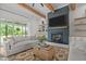 Cozy living room with a shiplap fireplace, wood beams, and sliding glass doors at 2408 Eddie Howard Rd, Willow Springs, NC 27592