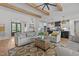 Open-concept living room and kitchen with hardwood floors and exposed beams at 2408 Eddie Howard Rd, Willow Springs, NC 27592