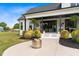 Charming patio with stylish landscaping, fire pit, covered space, and comfortable seating for relaxing outdoors at 2408 Eddie Howard Rd, Willow Springs, NC 27592