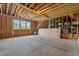 Unfinished room showing wood framing, potential for customization, and natural light at 2408 Eddie Howard Rd, Willow Springs, NC 27592