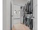 Well-organized walk-in closet connecting to the primary bathroom suite at 2408 Eddie Howard Rd, Willow Springs, NC 27592
