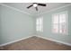 Bedroom featuring neutral carpet, light green walls, and two large windows with white shutters at 2412 Mollynick Lane Ln, Wake Forest, NC 27587