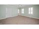 A bedroom with carpet, many windows, and light-colored walls at 2412 Mollynick Lane Ln, Wake Forest, NC 27587