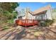 Exterior view of a back deck and a stone chimney with siding at 2412 Mollynick Lane Ln, Wake Forest, NC 27587