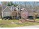 Beautiful one-story home with dormer windows, mature trees, and manicured landscaping at 2412 Mollynick Lane Ln, Wake Forest, NC 27587