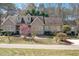 Charming single-story home with a manicured lawn, flowering trees, and gray siding at 2412 Mollynick Lane Ln, Wake Forest, NC 27587