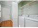 Functional laundry area with washer, dryer, and a folding door at 2412 Mollynick Lane Ln, Wake Forest, NC 27587