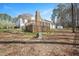 Backyard with a wood deck, storage building, and mature trees at 2420 Mollynick Ln, Wake Forest, NC 27587