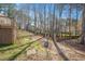 Tree-lined backyard featuring a black metal fence at 2420 Mollynick Ln, Wake Forest, NC 27587