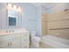 Bright bathroom with a white vanity, tiled shower with a grab bar, and classic fixtures at 2420 Mollynick Ln, Wake Forest, NC 27587