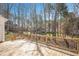 Spacious wooden deck overlooking a private backyard with mature trees and a neighboring house at 2420 Mollynick Ln, Wake Forest, NC 27587