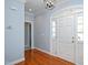 Entryway with gleaming hardwood floors, arched doorway and trimmed in crown molding at 2420 Mollynick Ln, Wake Forest, NC 27587
