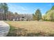 Beautiful home exterior with a large yard and mature trees offering privacy at 2420 Mollynick Ln, Wake Forest, NC 27587