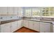 This Kitchen features tile backsplashes, white cabinets, and stainless steel appliances at 2420 Mollynick Ln, Wake Forest, NC 27587
