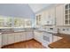 Traditional kitchen with white cabinets, wood countertops, and bright natural light at 2420 Mollynick Ln, Wake Forest, NC 27587