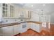 A bright, spacious kitchen with hardwood floors, white cabinets and countertops, and open to the living room at 2420 Mollynick Ln, Wake Forest, NC 27587