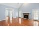 Bright living room featuring hardwood floors and a stone fireplace at 2420 Mollynick Ln, Wake Forest, NC 27587
