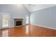 Bright living room featuring hardwood floors, a stone fireplace, and a vaulted ceiling at 2420 Mollynick Ln, Wake Forest, NC 27587