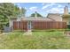 Grassy backyard features a wooden fence, patio entrance, and access to outdoor living at 2617 Cottage Cir, Raleigh, NC 27613