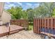 Backyard view of a deck, patio and a green grass lawn that extends to the back of the property at 2617 Cottage Cir, Raleigh, NC 27613