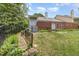 Fenced backyard with grassy area and pathway, offering privacy and outdoor space at 2617 Cottage Cir, Raleigh, NC 27613