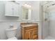 This is a bathroom featuring a granite vanity, mirror, and a walk-in shower with glass doors at 2617 Cottage Cir, Raleigh, NC 27613
