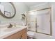 Well-maintained bathroom with a vanity sink, toilet, and bathtub with glass sliding doors at 2617 Cottage Cir, Raleigh, NC 27613