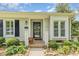 Inviting front porch showcasing a decorative wreath, seating, potted plants, and well-maintained landscaping at 2617 Cottage Cir, Raleigh, NC 27613