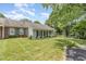 Well-maintained home with lush lawn, manicured landscaping, and a mix of brick and siding exterior at 2617 Cottage Cir, Raleigh, NC 27613