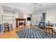 Cozy living room with hardwood floors, fireplace, built-in shelving, and access to the patio at 2617 Cottage Cir, Raleigh, NC 27613