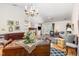 Spacious living area with hardwood floors, dining table, fireplace, and vaulted ceilings at 2617 Cottage Cir, Raleigh, NC 27613
