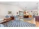 Open-concept living area with hardwood floors, dining area, and comfortable seating arrangements at 2617 Cottage Cir, Raleigh, NC 27613