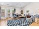 Bright living room featuring hardwood floors, a vaulted ceiling, and comfortable seating arrangements at 2617 Cottage Cir, Raleigh, NC 27613