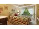 Sunny bedroom with a floral-patterned bedspread and large windows at 2713 Mcdowell Rd, Durham, NC 27705